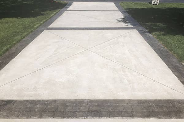 Round organic shaped grey concrete patio installation